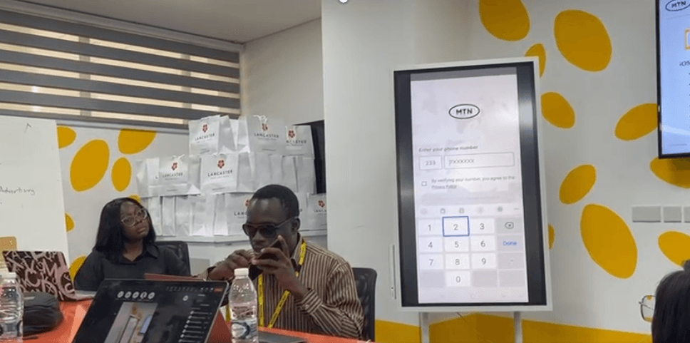 Usability testing session: participant using the myMTN app while the room observes on a large screen